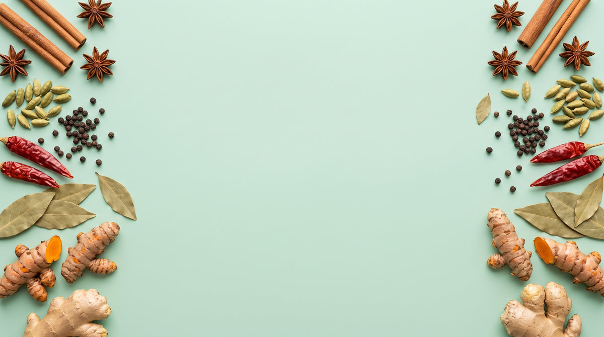 Whole spices arranged on mint green surface - Yemen Spices collection banner